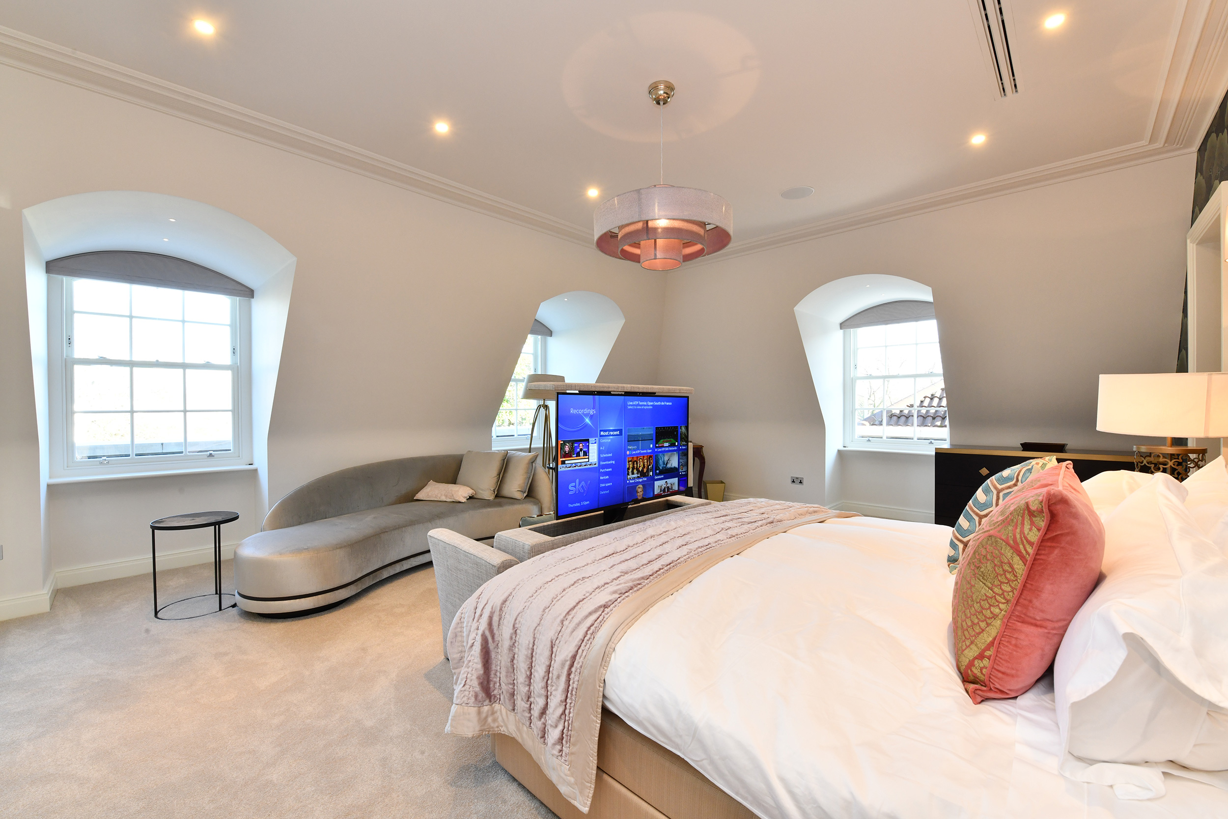 Bedroom TVs are on motorised lifts inside bespoke seating units; they can rotate to face bed or seats